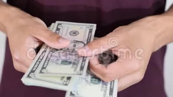 一个人漫不经心地把一包美元记在手里美元视频的预览图