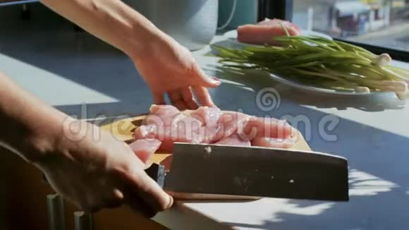 双手将肉盒放入明亮的日光灯下的锅中视频的预览图