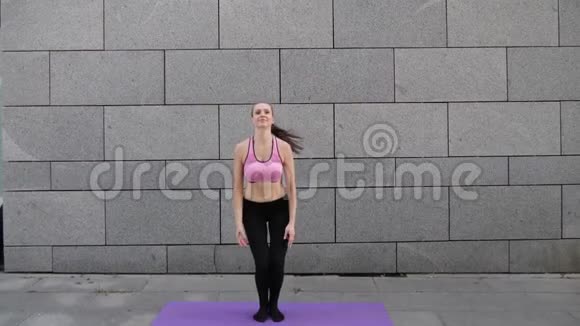 健身瑜伽女运动员在运动前热身跳跃慢动作视频的预览图