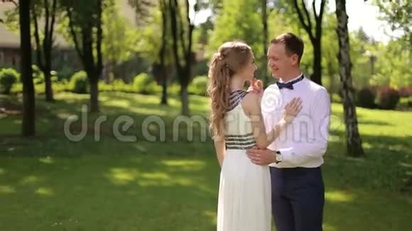 一对新婚夫妇站在公园拥抱视频的预览图