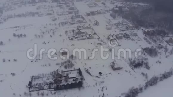 在冬天的村庄里飞行黎明时分在德龙上下雪视频的预览图