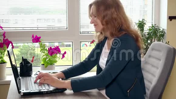 孕妇在笔记本电脑上打字并做笔记视频的预览图