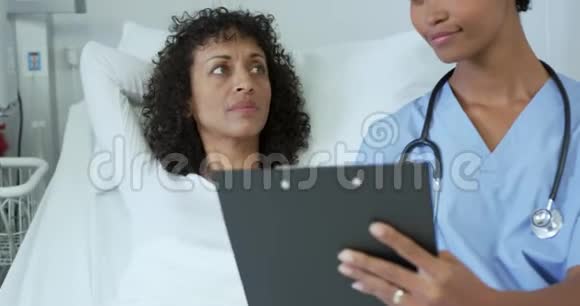 非裔美国女医生在医院病房与女病人交谈的正面看法视频的预览图