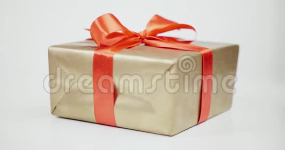 礼物用金色的纸包裹系着红色丝带蝴蝶结视频的预览图