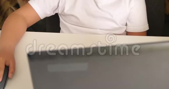 儿童在白色桌子上的笔记本电脑附近使用电脑鼠标视频的预览图