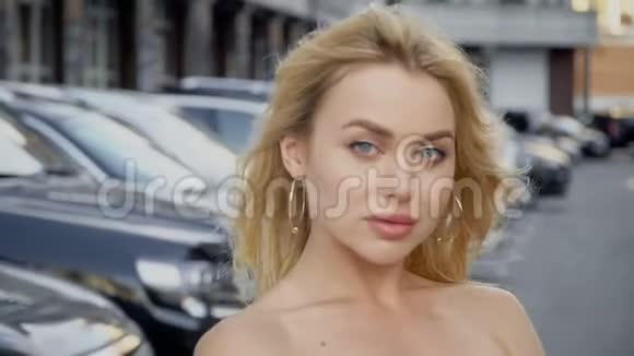 一个金发碧眼的金发碧眼的人在停车场的背景上的肖像视频的预览图