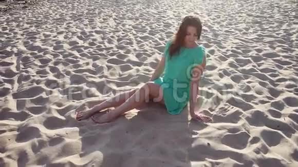 平均计划美丽的女孩在海滩上玩沙子视频的预览图