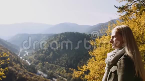 后景女性站在悬崖上看日出叹为观止太阳光线照射她视频的预览图