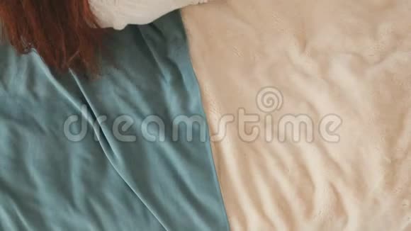 可爱的红头发女人躺在床上看书视频的预览图