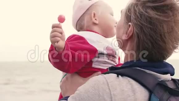 海滩上的父亲和小女儿风吹在头发上视频的预览图