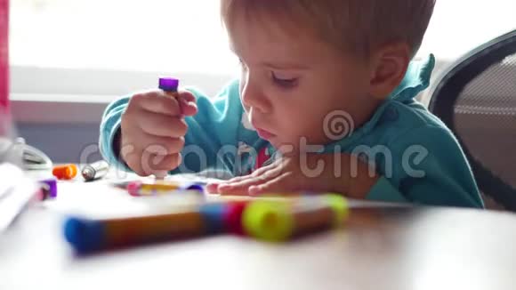 孩子在一张纸上热情地用蜡笔画画学前教育视频的预览图