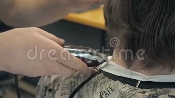 美发师在沙龙里给顾客剪脖子和后脑勺的长发坐在发廊扶手椅上的男人视频的预览图