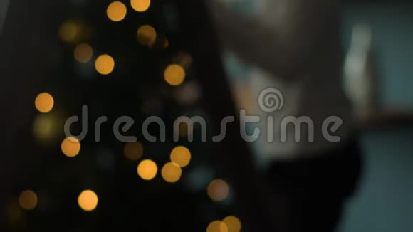 小男孩站在家里的圣诞树旁视频的预览图
