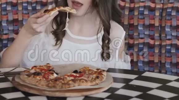 在咖啡馆里吃披萨的漂亮女孩的特写照片慢慢地视频的预览图