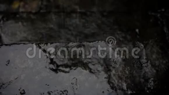 雨水落在粗糙不平的水泥地板上的视频镜头视频的预览图