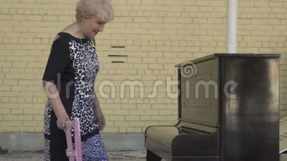 美丽的老妇人来弹钢琴视频的预览图
