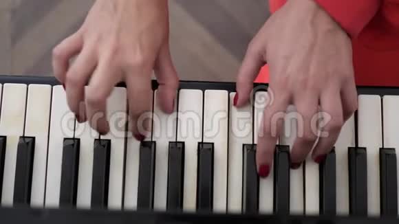 两只美丽的红手指甲弹钢琴视频的预览图