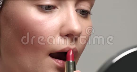 特写女人用红色口红做嘴唇视频的预览图