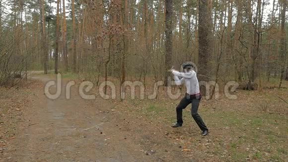 在森林里用虚拟现实眼镜和棍子打架的年轻人视频的预览图