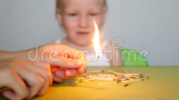 母亲点燃火柴教导小孩不能拿火柴否则后果自负视频的预览图