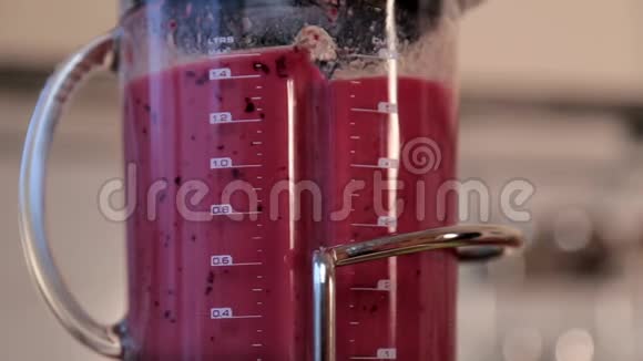 女人在搅拌机里做水果奶昔视频的预览图