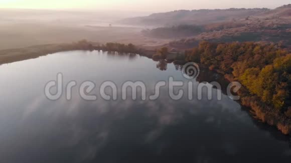 飞越湖面水面上有雾晨雾霾无人机雾雾过湖秋天的气雾秋天视频的预览图
