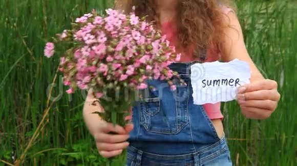 夏有字和粉红色花的年轻女子视频的预览图