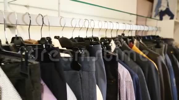 商场里穿着休闲服的陌生人特写衣服的衣架衣架设计师服装系列视频的预览图