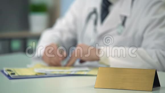 主治医生在诊所开药桌上有铭牌模板视频的预览图
