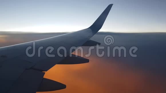 日落时飞机在天空中高高飞起从侧面窗口查看视频的预览图
