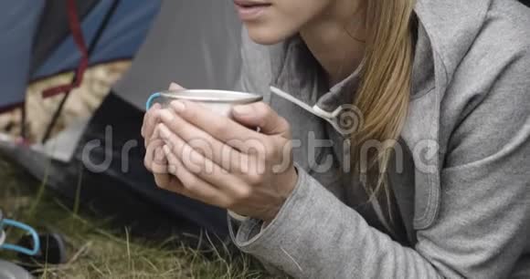 女人在露营帐篷里喝热饮料情侣恋爱秋日户外旅行自然秋天的晴天4k视频的预览图