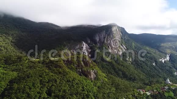 斯里兰卡亚当山顶上覆盖着云层的高山森林和瀑布的鸟瞰图视频的预览图