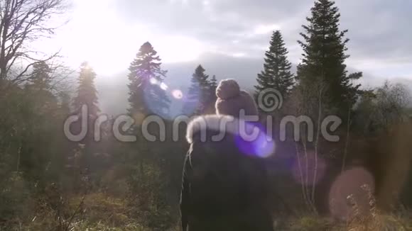 女孩走在秋天的森林里在山上慢悠悠视频的预览图