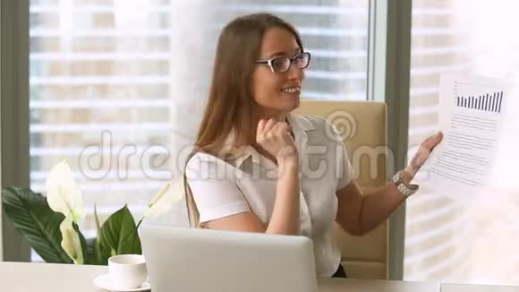 微笑的女商人展示商业文件在镜头上显示不断增长的图表视频的预览图