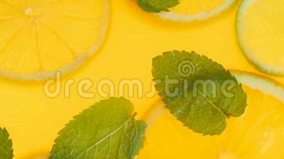 特写4k视频新鲜薄荷叶和橘子片漂浮在柠檬水中视频的预览图