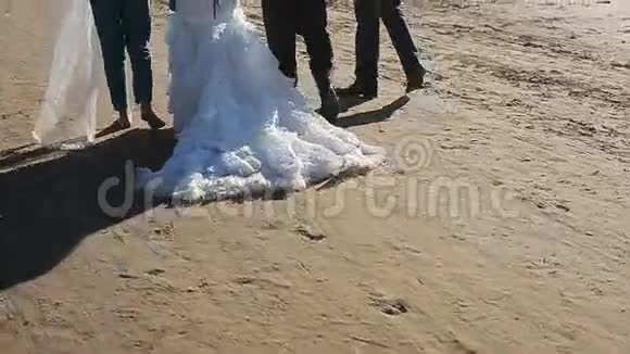 新娘和朋友在海滩散步视频的预览图