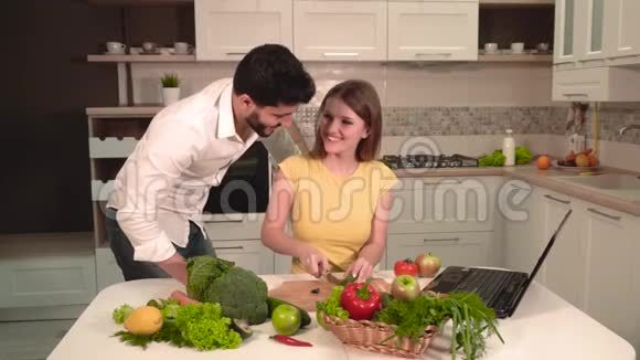 快乐夫妇用笔记本电脑烹饪视频的预览图