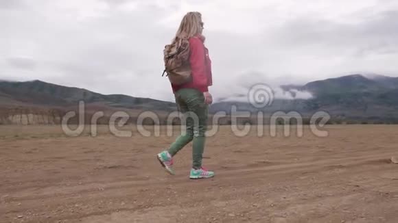 希克在恶劣的天气里行走在山区山峰下面的云带游客徒步旅行的女孩视频的预览图