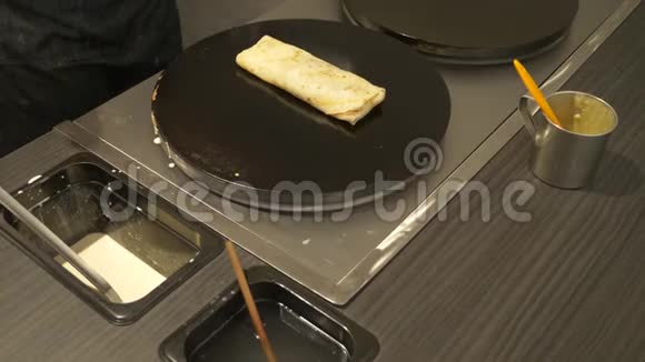 特写镜头在特殊设备上烹饪煎饼视频的预览图