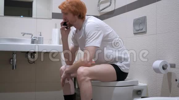 红发男子在厕所里讲电话社区视频的预览图