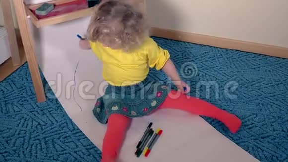 有趣的艺术家儿童画用铅笔在纸上坐在地板上视频的预览图