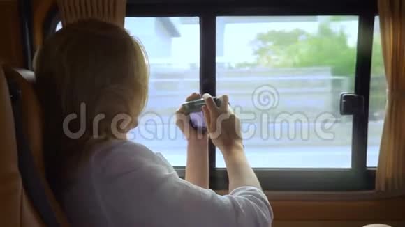 一个女人从一辆现代汽车上拍摄摩天大楼的照片视频的预览图