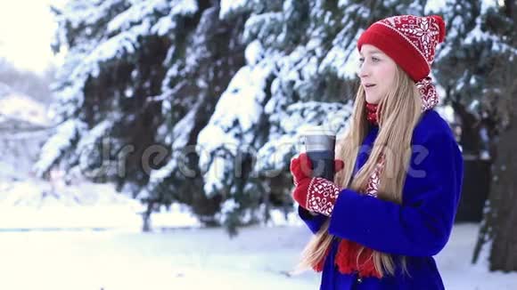 穿着冬装享受热饮的可爱女人视频的预览图