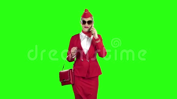 穿着红色西装的女服务员在电话里说话然后走开了绿色屏幕慢动作视频的预览图
