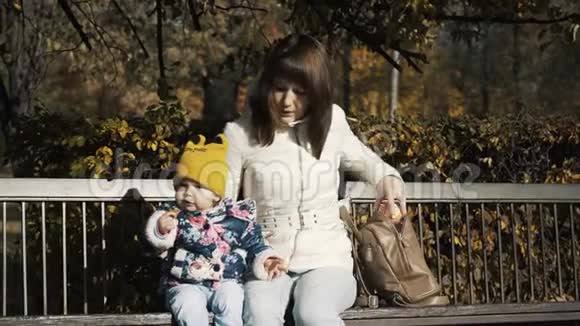 在公园户外由母亲喂养婴儿头几个星期就哭了妈妈和吃孩子夏天在长凳上好的胃口视频的预览图