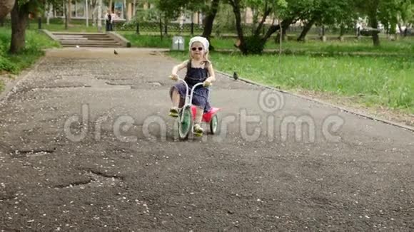 小女孩骑三轮车或三轮车慢动作视频的预览图