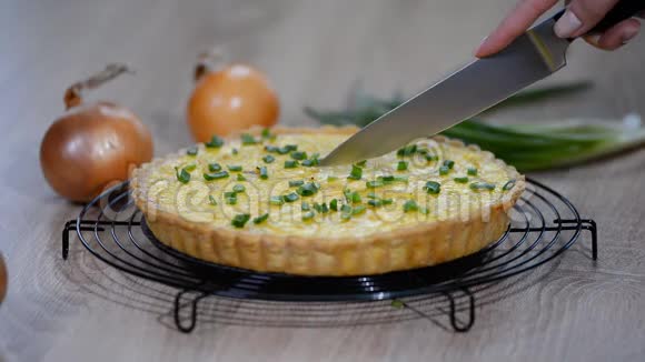 加洋葱和奶酪的法国馅饼用菜刀切洋葱派视频的预览图