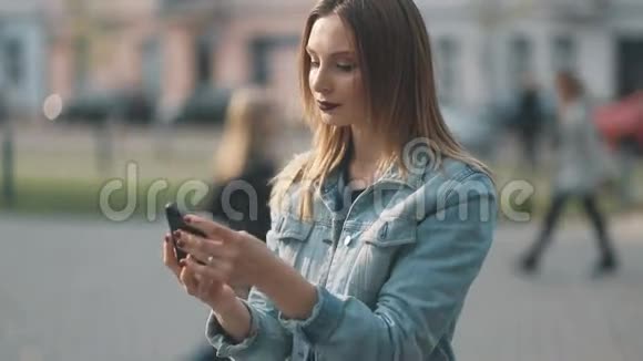 一位年轻的金发女孩在蓝牛仔布球场用深红的嘴唇和严严实实的模糊镜头做侧对前额特写视频的预览图