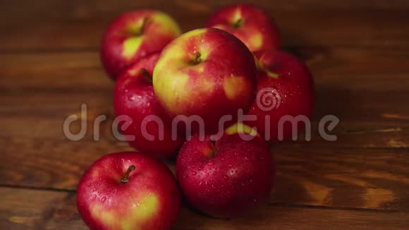 一堆红色的开胃苹果放在深色的木桌上视频的预览图