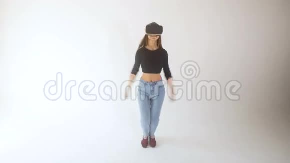 在虚拟现实中很有趣一个女孩戴着VR耳机看上去很高兴视频的预览图